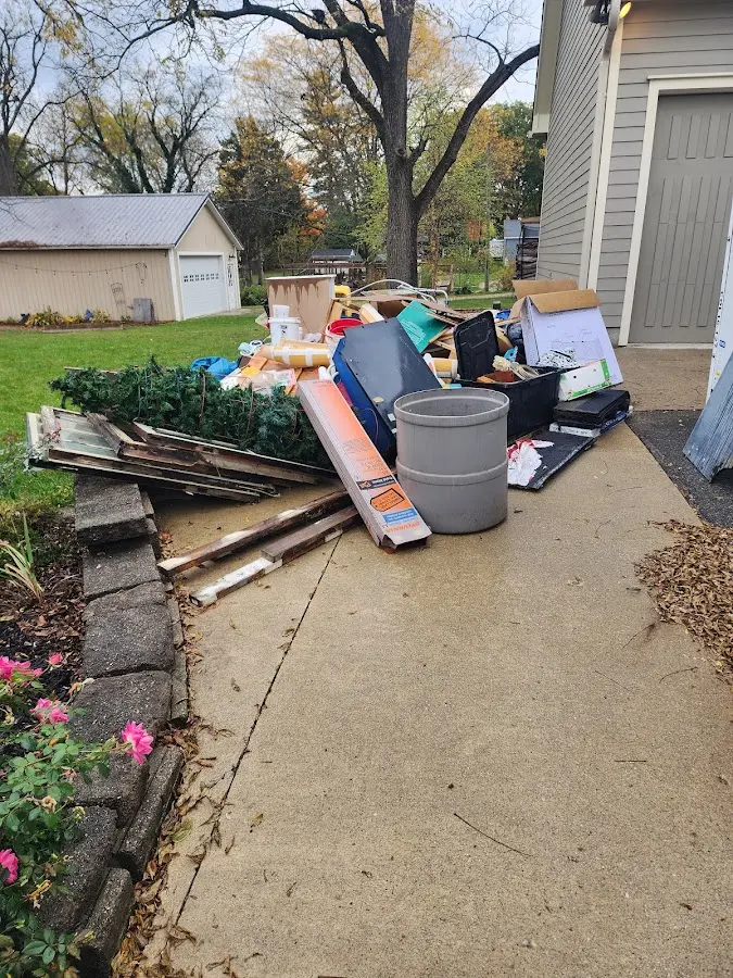 Dumpster being loaded with debris for Demolition Dumpster Rental in Brewer